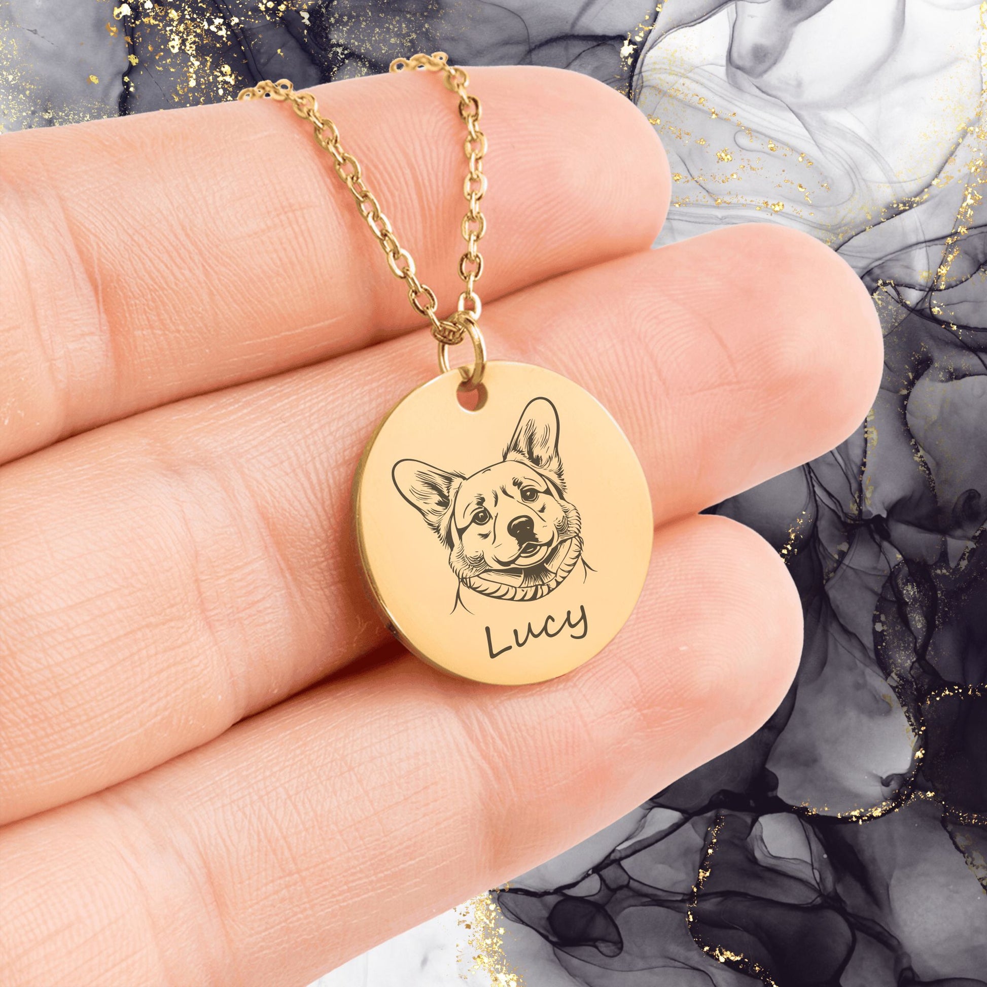 personalized pet portrait necklace in gold held in a person's hands