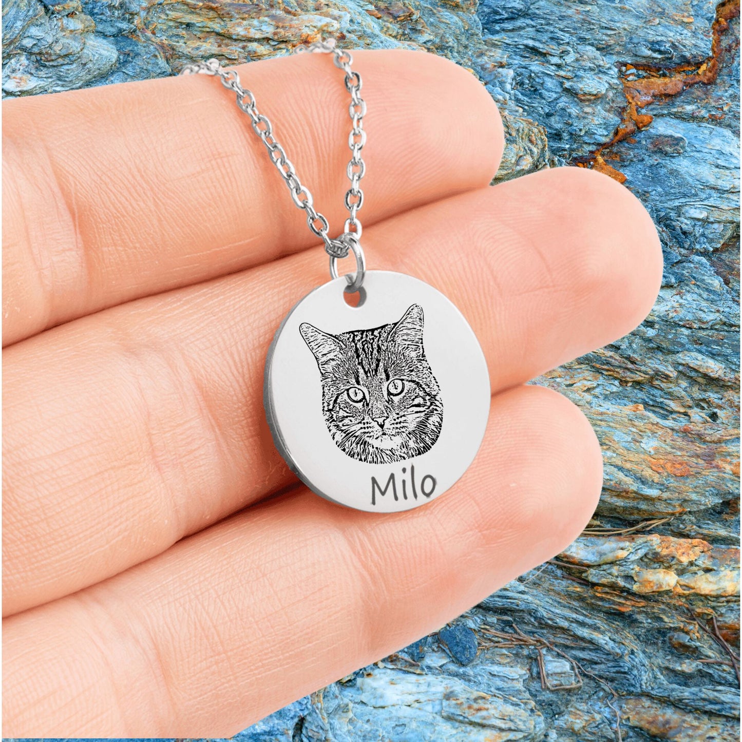 custom cat picture necklace in silver held in a hand