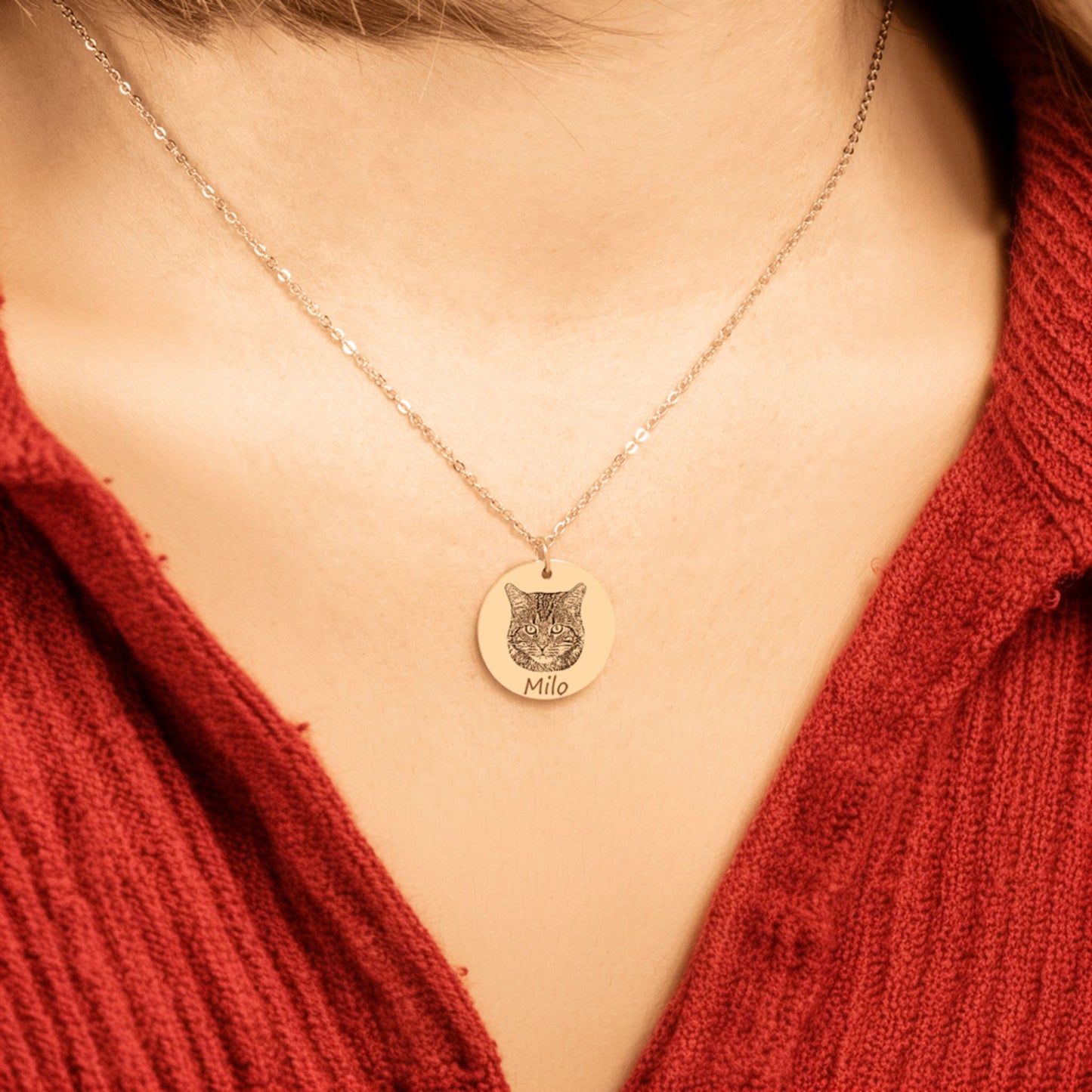 custom cat photo necklace in gold worn by a woman in a red shirt