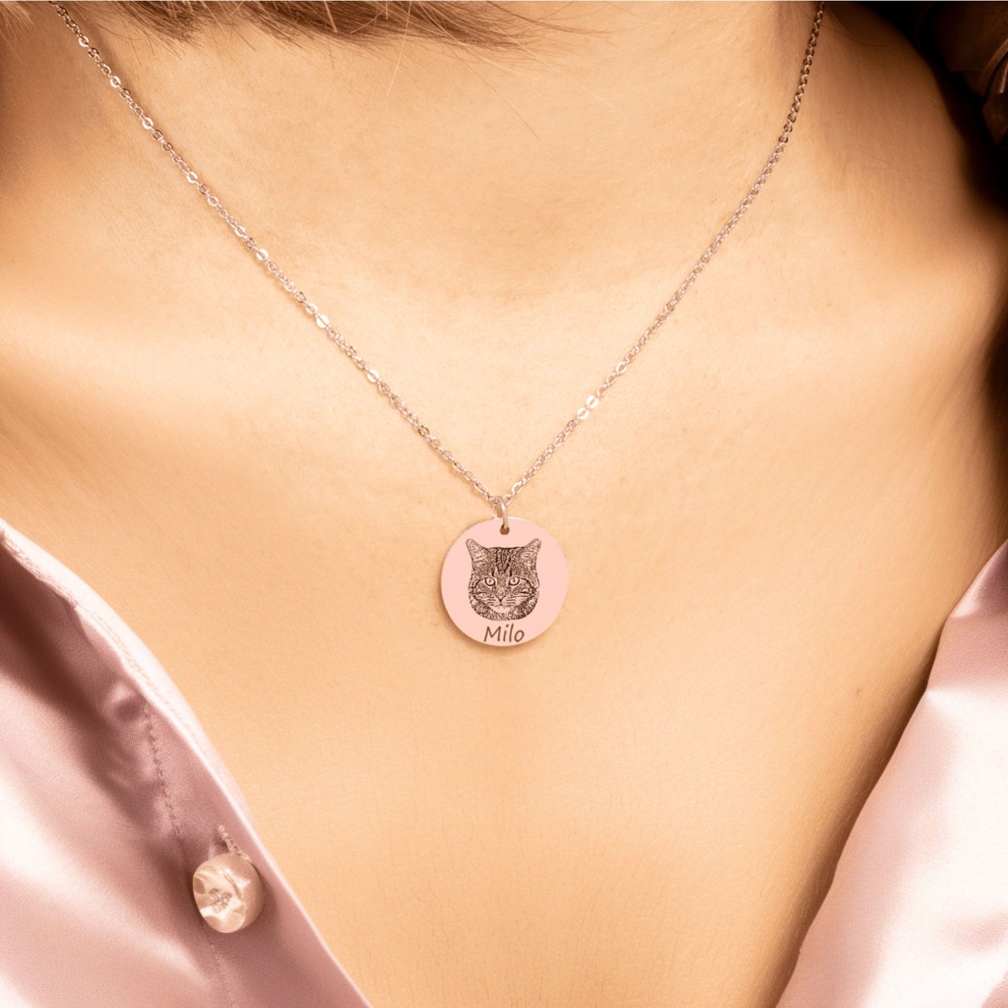 custom cat portrait necklace in rose gold worn by woman in a pink shirt