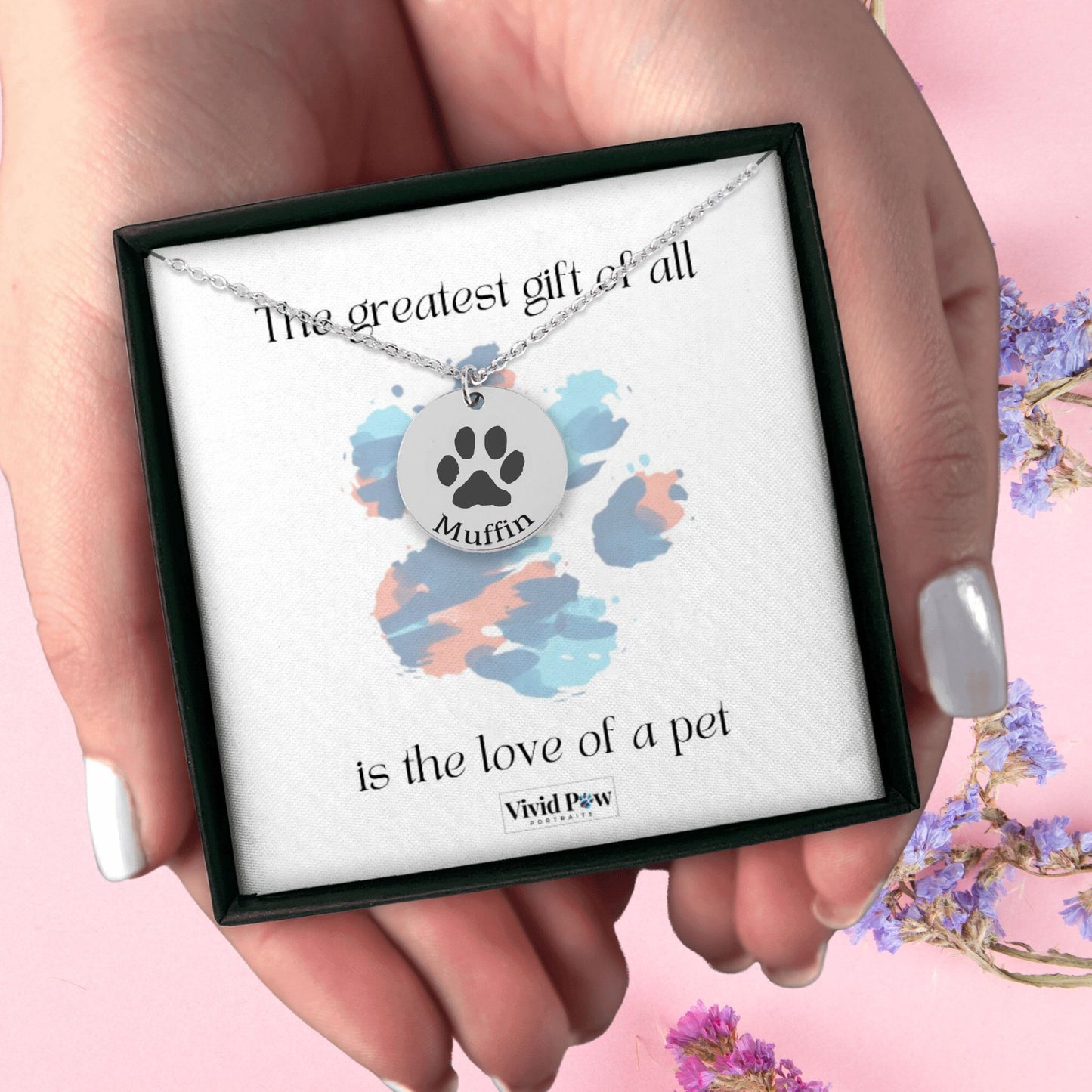 personalized pet paw print necklace in silver in a black gift box held in hands