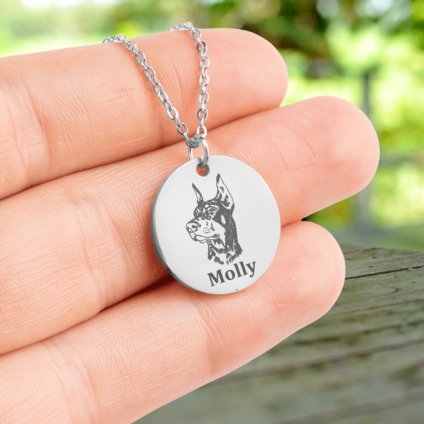 customized pet photo necklace in silver held in hands