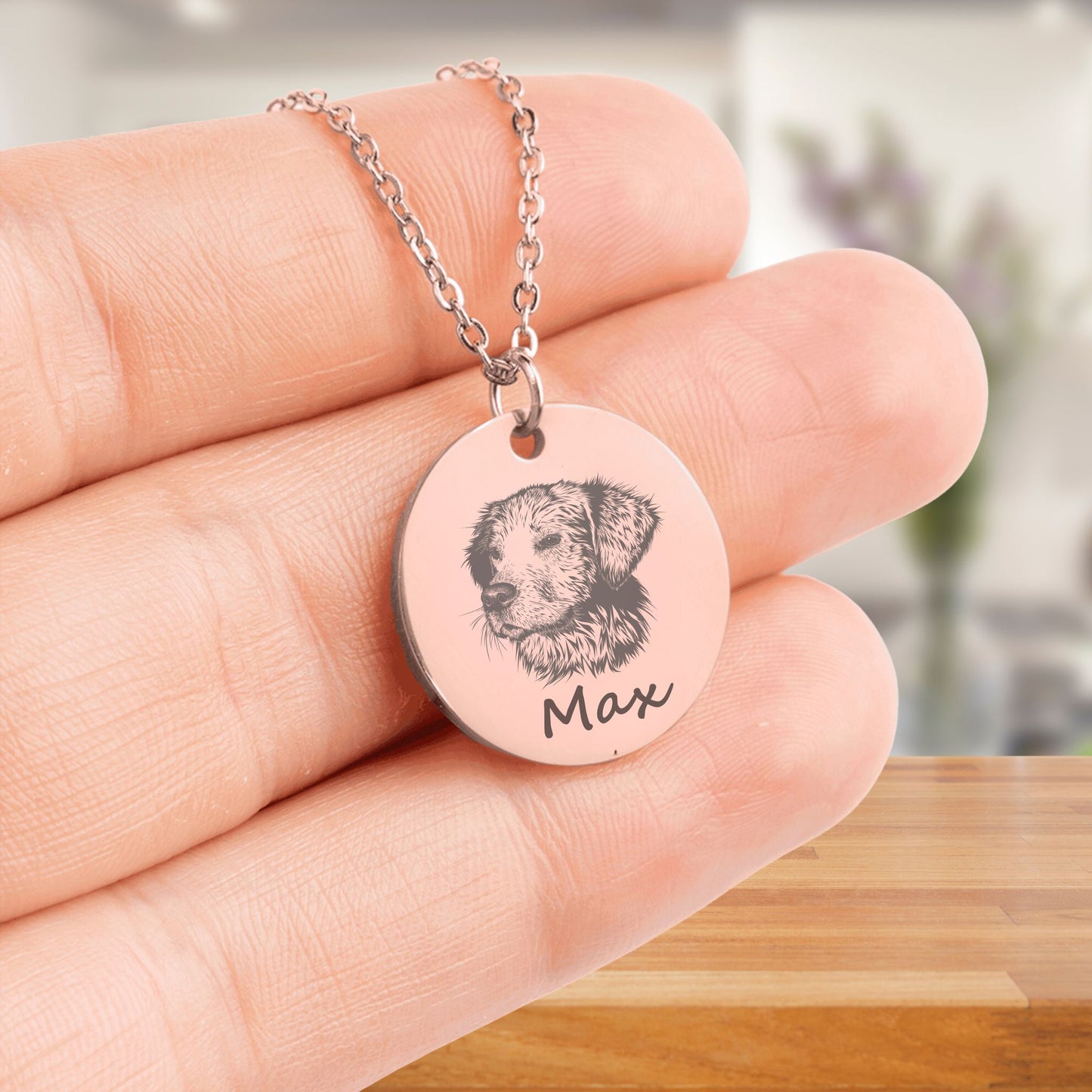 custom pet portrait necklace in rose gold held in hands