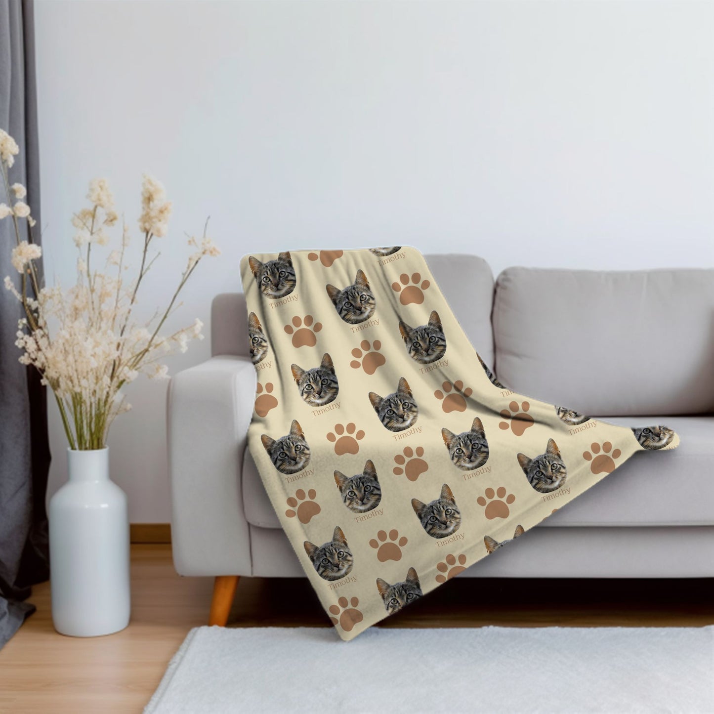custom cat face picture and name blanket in sand/camel on a couch