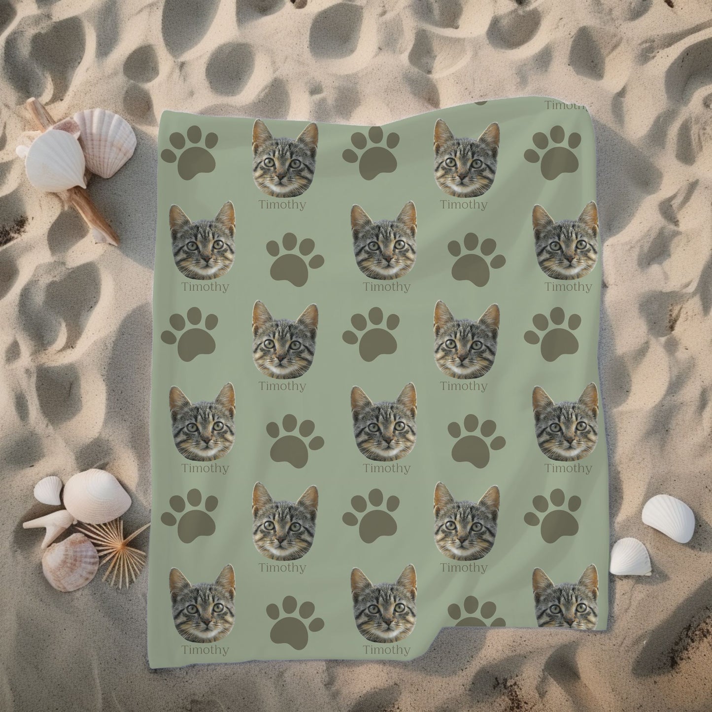 personalized cat face and name blanket in sage/olive on a sandy beach